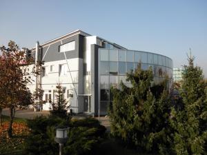 a large glass building with trees in front of it at Rooms Cipot in Murska Sobota