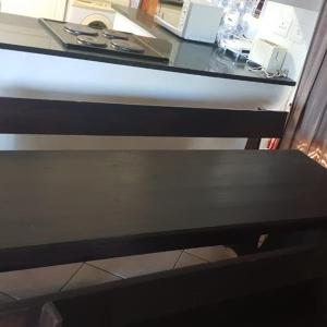 a black bench sitting under a counter top at Log Cabin Ramsgate in Margate