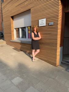 a woman standing in front of a wooden wall at Huis Buizemont in Geraardsbergen