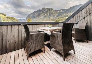 a patio with a table and chairs on a deck at Haus Moosbrugger in Mellau