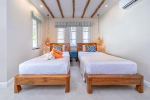 2 camas individuais num quarto com 2 janelas em Samed Villa Resort em Ko Samet