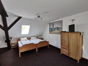 um quarto com 2 camas, uma televisão e uma cómoda em Bleckmanns Hof em Werne an der Lippe