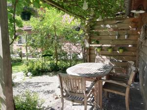 a table and two chairs sitting under a pergola at Vakantiewoning-deblinker in Sint-Laureins