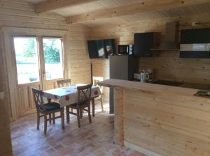 a kitchen and dining room with a table and chairs at Blockhaus Harzblick4C in Braunlage