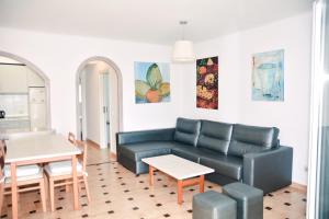 sala de estar con sofá y mesa en Rosamar Holidays Apartments, en Cala Ratjada