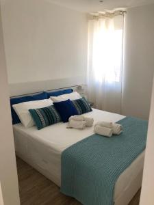 a large bed with two pillows on top of it at Angel in Pozzallo