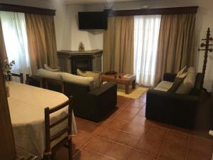 a living room with couches and a bed and a fireplace at Casa Lola Principe in Geres