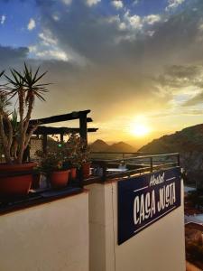 a sign for a caza wish on a wall with plants at Boutique Hostal "Casa Justa" in Mojácar