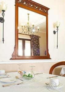 a dining room table with a mirror on the wall at Roseland House in Durban