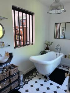 a bathroom with a white tub and a sink at Maison du bonheur in Villiers-sur-Marne