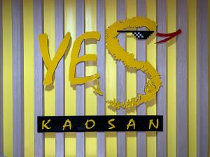 a yellow and black sign with the word vzarma at Yes Kaosan in Bangkok