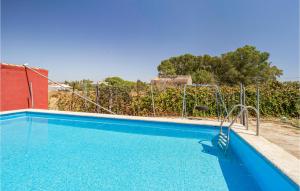 a blue swimming pool with a swing in a yard at 3 Bedroom Beautiful Home In Olivares in Olivares
