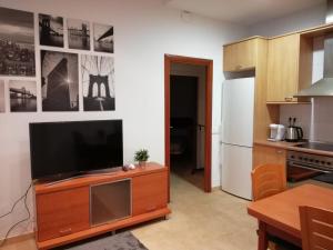 a living room with a television on a wooden entertainment center at Apartment Sabadell 2 in Sabadell