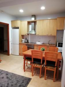 a kitchen with a table and chairs and a refrigerator at Apartment Sabadell 2 in Sabadell