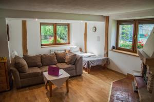 a living room with a couch and a table with a laptop at POKOJE GOŚCINNE WILCZNIK 12 in Zakopane