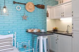 a kitchen with a blue brick wall and a counter at Apartment Alida in Krk