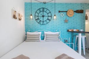 a bedroom with a bed with a blue brick wall at Apartment Alida in Krk