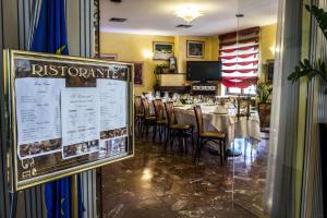 a dining room with tables and chairs and a flag at Nuovo Albergo in Chieti