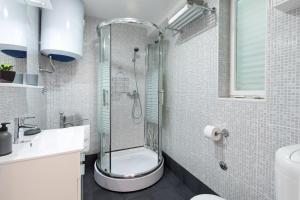 a bathroom with a shower and a toilet and a sink at Apartment Alida in Krk +38 photos