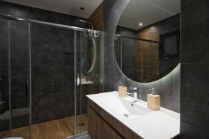 a bathroom with a sink and a shower at Acropolis View Penthouse N in Athens
