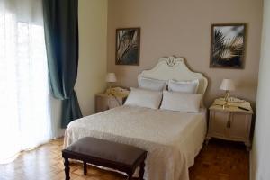 a bedroom with a large bed with two tables and a window at Casa Doramas B&B VV in Las Palmas de Gran Canaria