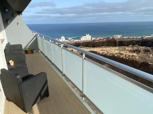 a balcony with chairs and a view of the ocean at Ático con vistas espectaculares in Bajamar