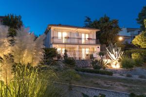a villa with a view of a garden at night at Apartment Alida in Krk