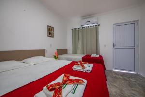 a bedroom with two beds with red bows on them at Luxury Flats Ambiente Cristão in Fortaleza