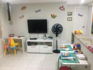 a living room with a flat screen tv on the wall at Lindo Ap 403 Quadra do Mar c Garagem in Recife