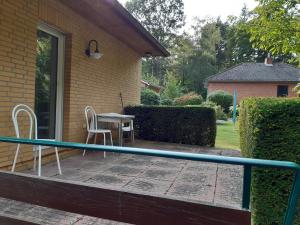 a patio with a table and chairs on a house at Vera in Hitzacker