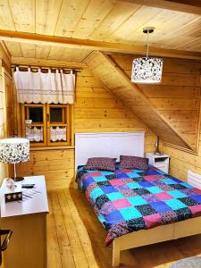a bedroom with a bed in a wooden room at Anielska Chata in Istebna