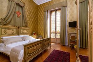 a bedroom with a large bed and a television at Casa della Contessa B&B in Turin
