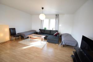 a living room with a couch and a table at Big Apartment in central Kiruna 6 in Kiruna