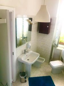 a bathroom with a sink and a toilet at A Casa Di Giallo B&B in Rome