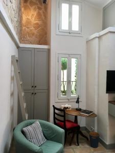 a living room with a table and a chair and a desk at Enjoy Mougins in Mougins