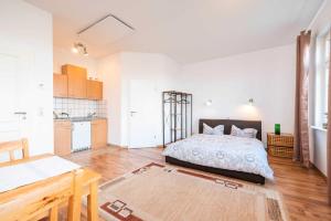 a large bedroom with a bed and a kitchen at Landhaus Karnin in Karnin (Usedom)