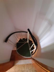 a spiral staircase in a room with a ceiling at Villetta Casale in Comano Terme