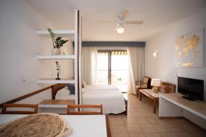 a hotel room with a bed and a living room at Apartamentos María Cristina Beach in Benidorm