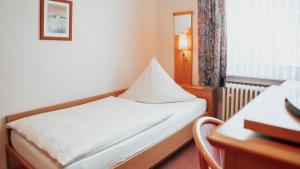 Postel nebo postele na pokoji v ubytování Avantgarde Hotel