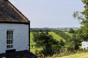 a white house with a view of a field at Craigmount in Wigtown