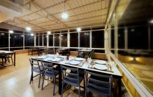 a dining room with a long table and chairs at Asha Lodges in Dhulikhel
