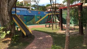 a playground with a slide in a park at CASA EM ÓTIMO CONDOMINIO DE BUZIOS in Búzios