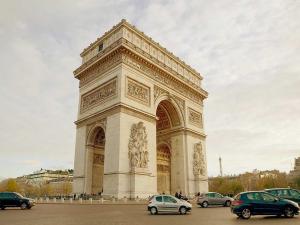 a large building with cars parked in a parking lot at Alma-Eiffel Tower in Paris