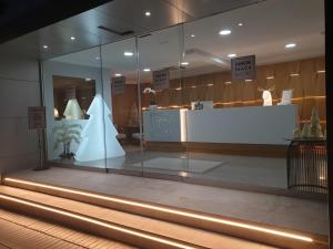 a display window of a store with a white counter at Sanom Beach Resort Only Adults in Playa del Ingles +30 photos