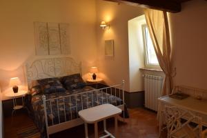 a bedroom with a bed and two tables and a window at Tenuta Donna Caterina in Tessennano +21 photos