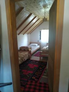 a room with a bedroom with a bed and a doorway at Prenociste B&M - Lukomir in Lukomir
