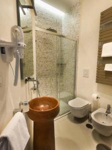 
a bathroom with a sink, toilet and bathtub at Relais Villa Montedonzelli in Naples
