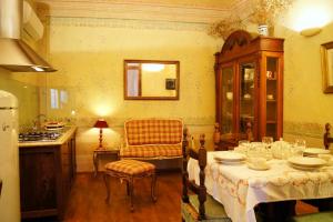 a kitchen with a table and a chair in a room at Melarancio Apartments in Florence