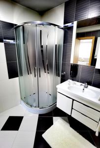 a bathroom with a shower and a sink at Hotel Acktion in Shumen