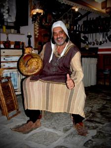 a man is sitting in a chair holding a bread at LT Lanzi - Frantoro in Viterbo